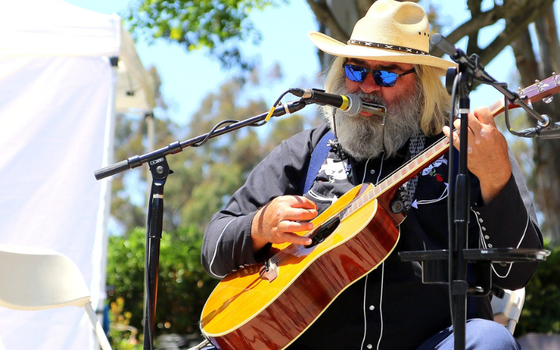 Harmonica John with his guitar and harmonica at Harp Fest 2024